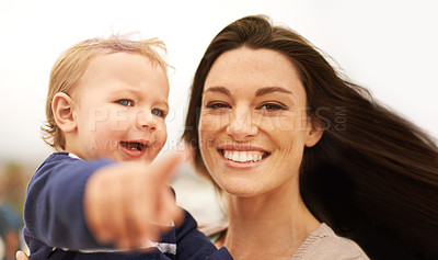 Buy stock photo Happy mom, portrait and baby pointing at beach for fun bonding, holiday or outdoor weekend together in nature. Face of mom, little boy or toddler with smile, enjoying sightseeing or travel in support