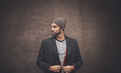 Buy stock photo Man, serious and thinking with fashion in winter for trendy, warm clothes and cool style by brown wall. Male person, pride and pose with confidence for outfit, contemplating and thoughtful with idea