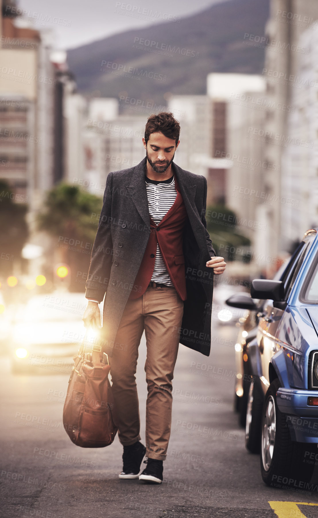 Buy stock photo Full length shot of a stylish young man walking through the city