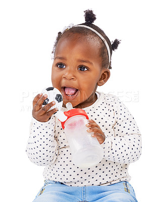 Buy stock photo Studio shot of a baby girl holding a bottle and a toy