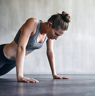 Buy stock photo Shot of a woman doing push-ups at the gym