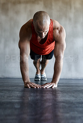 Buy stock photo Shot of a man doing a challenging workout at the gym