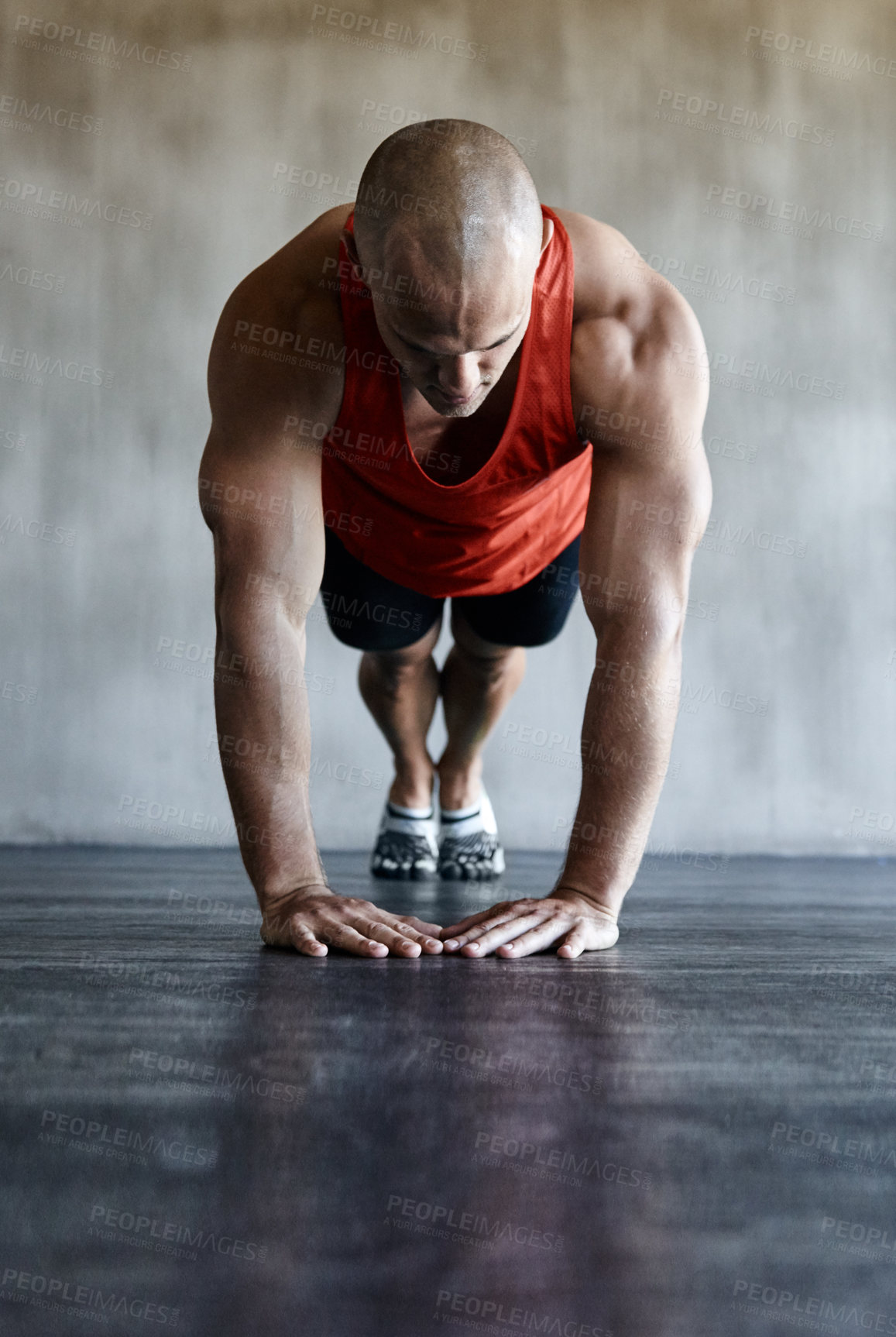 Buy stock photo Shot of a man doing a challenging workout at the gym