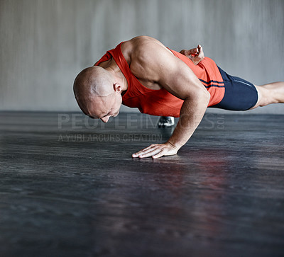 Buy stock photo Training, muscle strength and strong man doing push up for studio floor performance, gym routine or health club commitment. One arm pushup, motivation and male person workout, exercising or fitness
