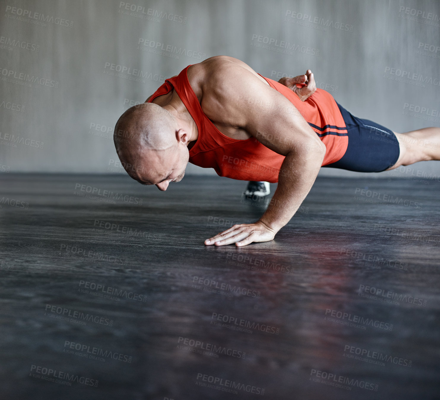 Buy stock photo Training, muscle strength and strong man doing push up for studio floor performance, gym routine or health club commitment. One arm pushup, motivation and male person workout, exercising or fitness