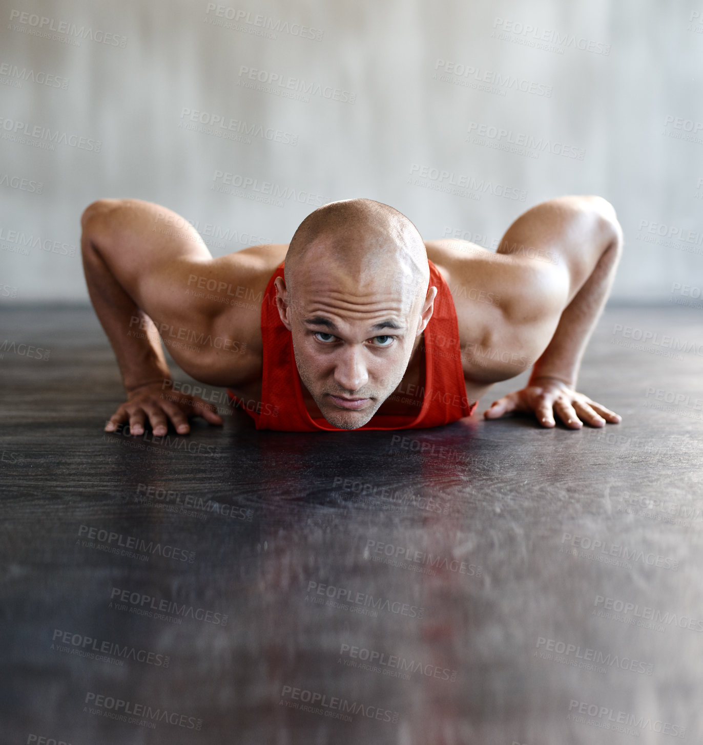Buy stock photo Shot of a man doing push-ups at the gym