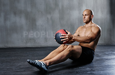 Buy stock photo Shot of a man doing exercises with a medicine ball at the gym