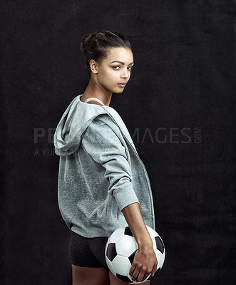 Buy stock photo Studio shot of a fit young soccer player against a black background
