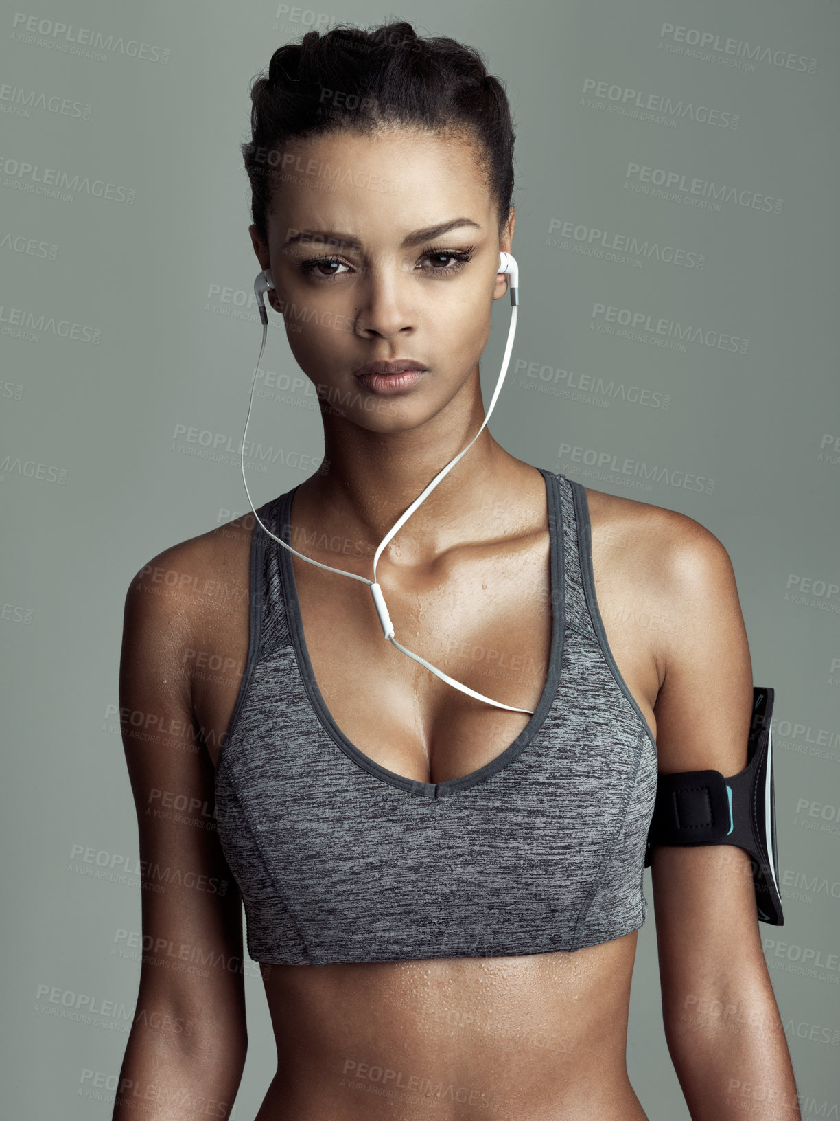 Buy stock photo Studio, portrait and athlete woman with earphones for streaming music, audio podcast or fitness playlist. Grey background, exercise and person for cardio workout, sports or physical training