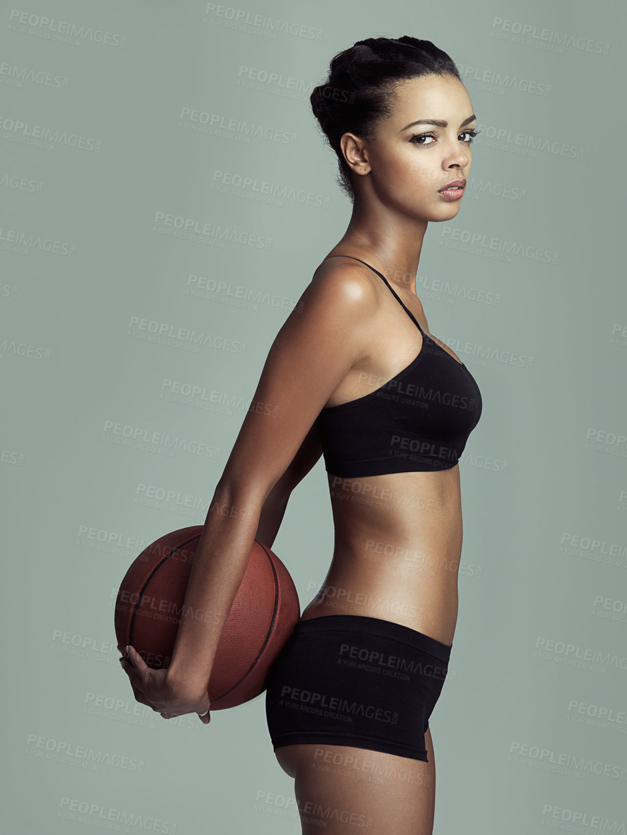 Buy stock photo Basketball, fitness and frown with portrait of woman in studio isolated on gray background. Exercise, sports or workout and athlete training with ball behind back for challenge, health or performance