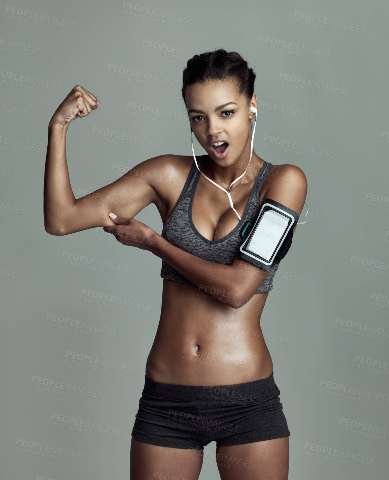 Buy stock photo Portrait, woman and bicep in studio for fitness with technology, music and streaming. Phone, muscle flex and athlete on background for wellness, online and podcast for weight loss and exercise