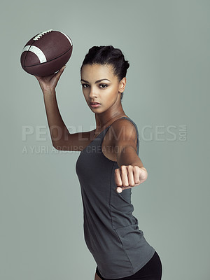 Buy stock photo American, football player and portrait of woman in sport on studio background with fitness in game. Athlete, training and girl practice for match, competition and throw ball in exercise or challenge