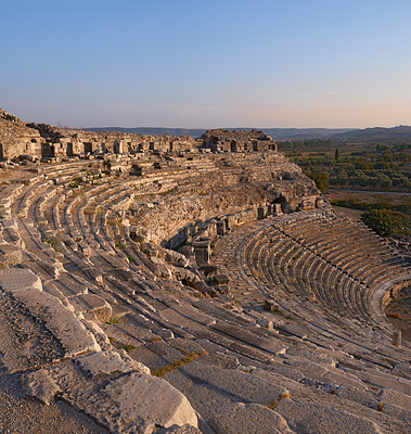 Buy stock photo Landscape, outdoor and ancient Greek ruins with stone, wall and architecture for tourism landmark. Building, ampihitheater or stadium in nature with culture, heritage and history in Bodrum, Turkey