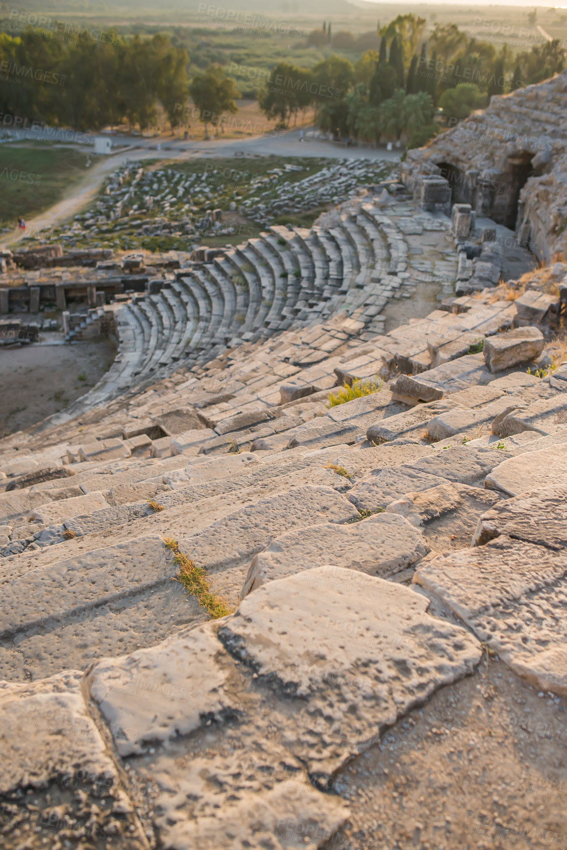 Buy stock photo Landscape, architecture and ancient Greek ruins with stone, wall and outdoor for tourism landmark. Building, amphitheater or stadium in nature with culture, heritage and history in Bodrum, Turkey