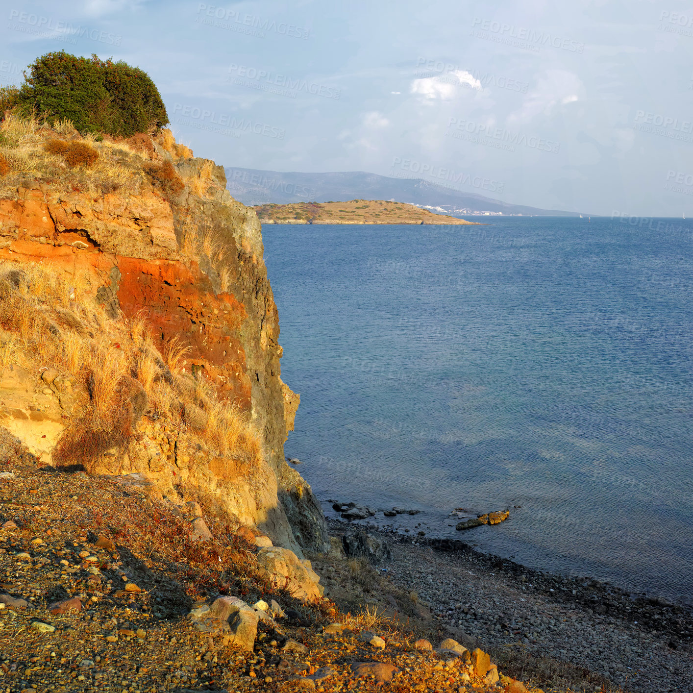 Buy stock photo Landscape, beach and outdoor with cliff, rock and waves in nature, tourism and location with mountains on horizon. Ocean, view or water by shoreline with clouds, sky and seascape in Bodrum, Turkey