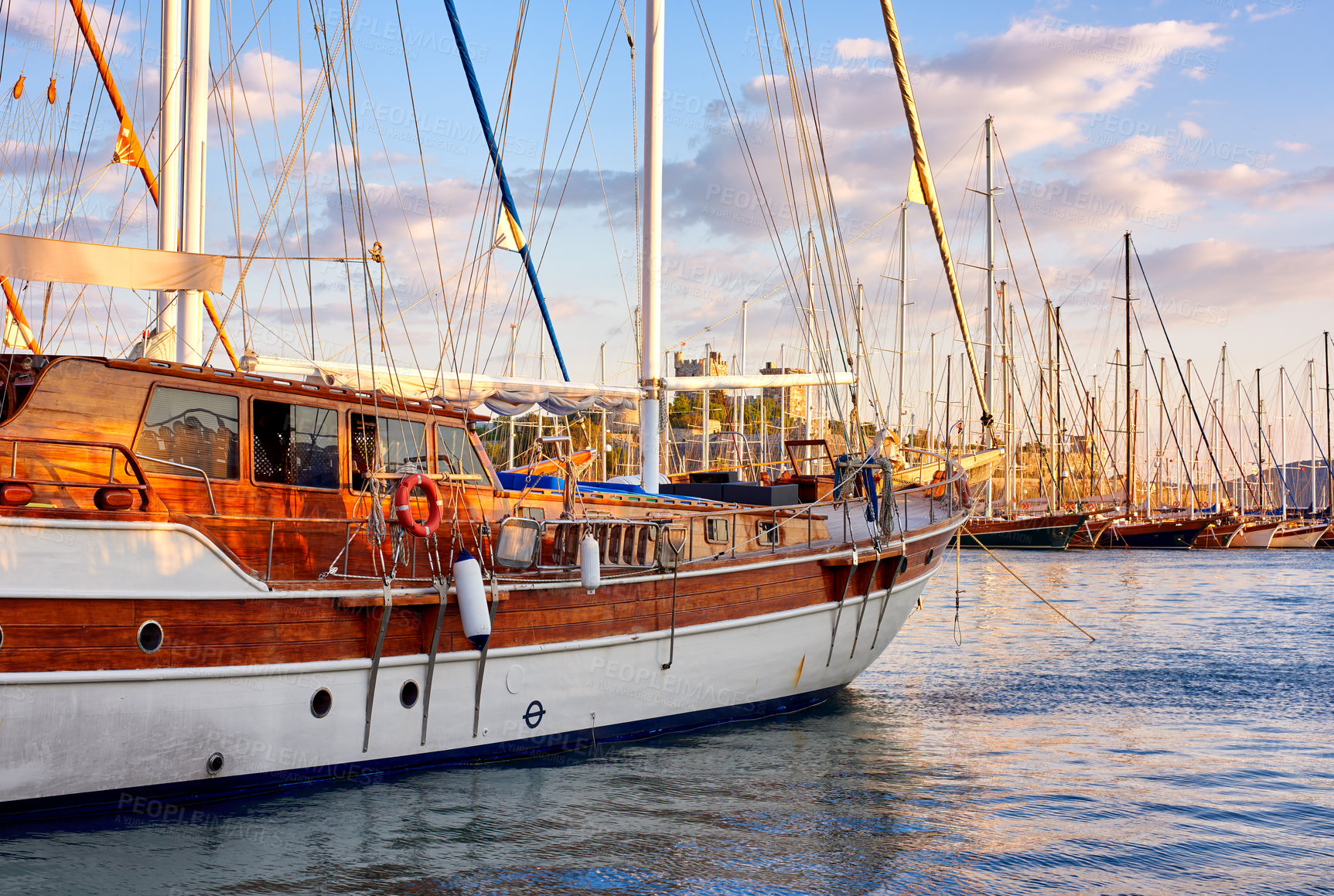 Buy stock photo Group of boats docked in a harbor of Bodrum in Turkey at sunset. Scenic view of sailing yachts in cruise port and bay at dusk. Empty dockyard in Aegean sea in evening. Tourism abroad, overseas