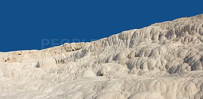 Buy stock photo Landscape of the Travertine pools and terraces in Pamukkale Turkey. Desert sand with textured pattern against a blue sky. Tourism holiday destination at rock cotton castle location during hot springs