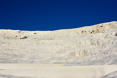 Buy stock photo Landscape of the Travertine terraces in Pamukkale, Turkey. Desert sand with curvy pattern texture against a blue sky. Tourism holiday destination at rock cotton castle location during hot springs