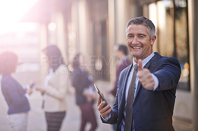 Buy stock photo A businessman showing thumbs up while standing with his digital tablet in the city