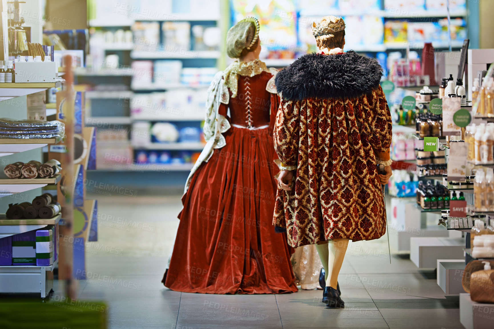 Buy stock photo Rearview shot of a king and queen looking at goods while shopping in a modern grocery store