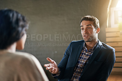 Buy stock photo Cropped shot of a man talking to his friend in a coffee shop