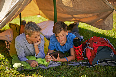 Buy stock photo Camping, adventure and kids in tent with tablet for outdoor activity, friends on vacation in park. Children, boys and freedom in nature with ebook for social media, online network with news in Europe