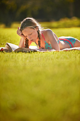 Buy stock photo Reading, girl and grass in nature for learning, storytelling and fantasy in sunshine. Young woman, tanning and book on blanket with bikini, education and studying outdoors in meadow for relaxation