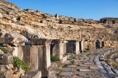 Buy stock photo Archeology, stone and forum from building exterior ruins for travel destination, sightseeing and historical monument. Medieval, brick and colosseum architecture in Middle east for tourism or landmark