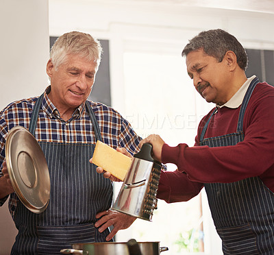 Buy stock photo Senior man, learning and cooking with cheese for pot or pasta dish in kitchen together at old age home. Male person, friends or team in hospitality with mixing ingredients, apron or recipe at house