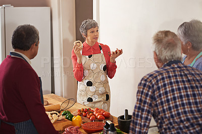 Buy stock photo Shot of a woman instructing a cooking class