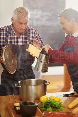 Buy stock photo Senior man, friends and cooking with pot for cheese or diary dish in kitchen together at old age home. Male person or team learning in hospitality with mixing ingredients, apron or recipe at house