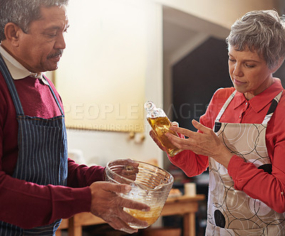 Buy stock photo Baking, home and mature couple in kitchen with meal prep for lunch, supper and dinner together. Marriage, love and man and woman with food, oil and ingredients for bonding, wellness and cooking