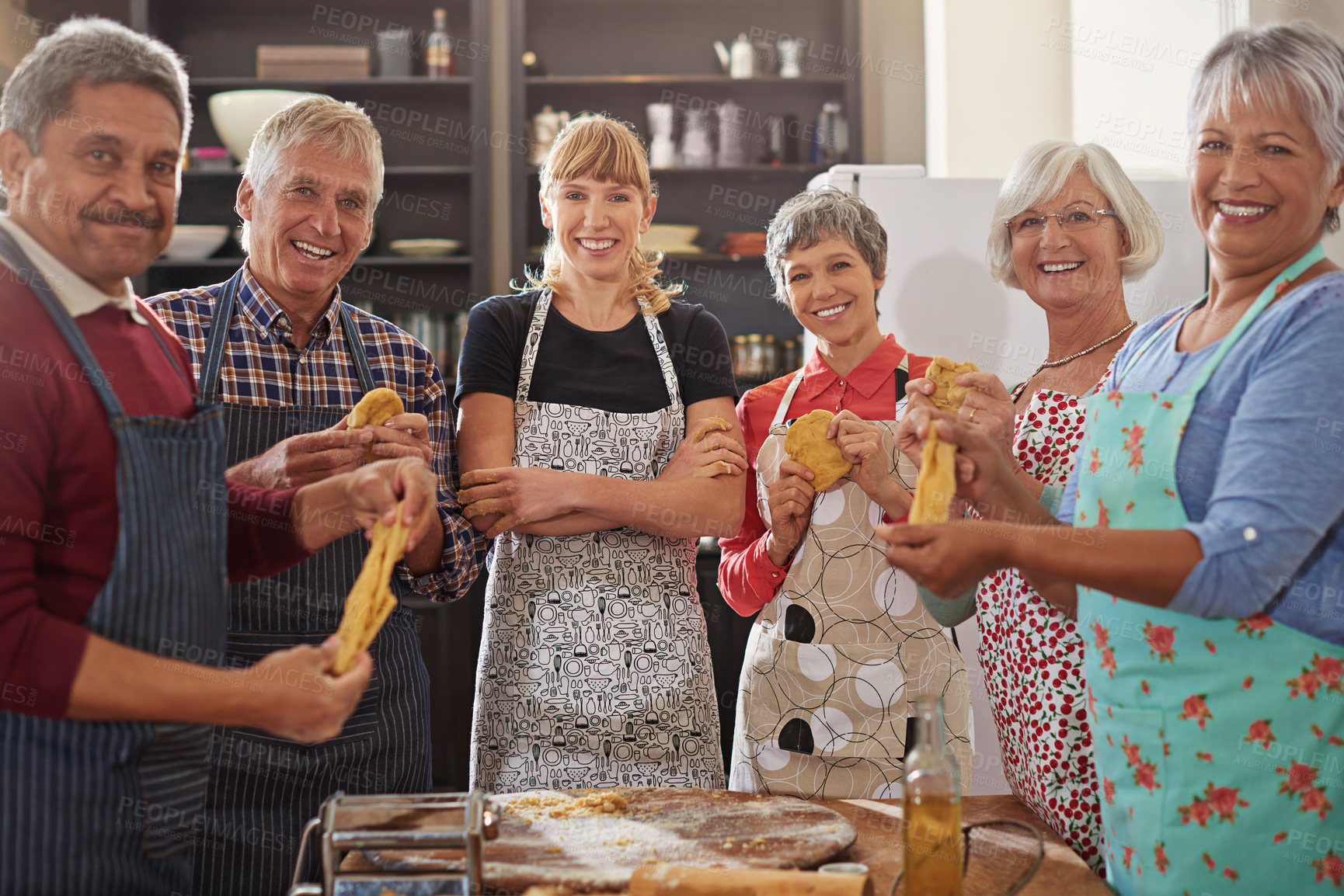 Buy stock photo Cooking, pasta class and portrait of people in kitchen learning recipe for cuisine, culinary and chef skills. Retirement, teacher and and men and women with ingredients, dough and food for dinner