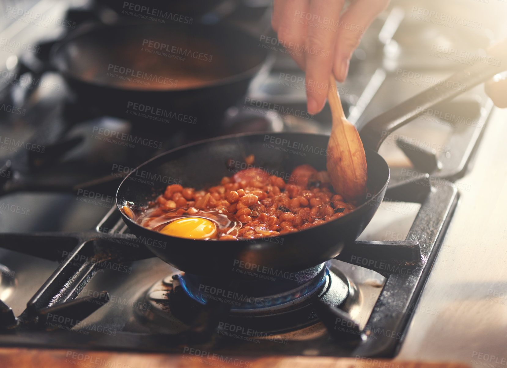 Buy stock photo Cooking, food and person with pan in kitchen on heat for meal prep for dinner, supper and lunch in home. Recipe, stove and hands with utensils with ingredients for wellness, nutrition and eating