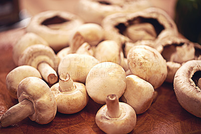 Buy stock photo Shot of mushrooms on a kitchen tabletop