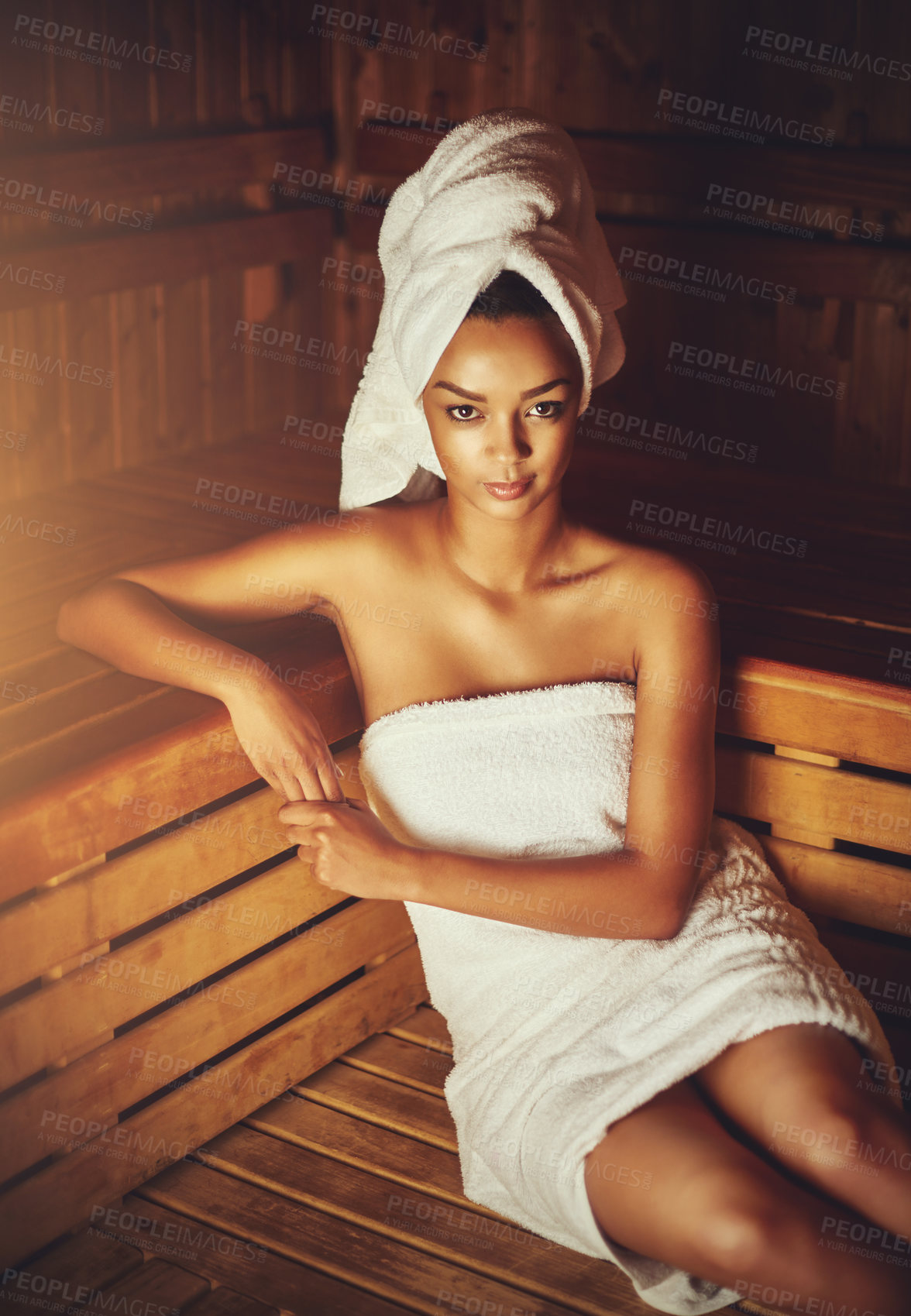 Buy stock photo Cropped portrait of a young woman relaxing in the sauna at a spa