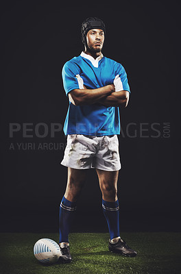 Buy stock photo Studio, night and rugby man with arms crossed for competition, training or sportswear on dark background. Confident, athlete and person by ball for professional sport, workout or exercise on grass