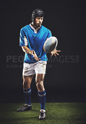 Buy stock photo Catch, man and ball for rugby sport or training for workout, fitness and skill for competition. Person or player on grass and athlete practice or active for football game or match on black background