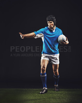 Buy stock photo Defend, man and ball for rugby sport or training for workout, fitness and skill for competition. Person or player on grass and athlete stop with hand or active for football game on black background.