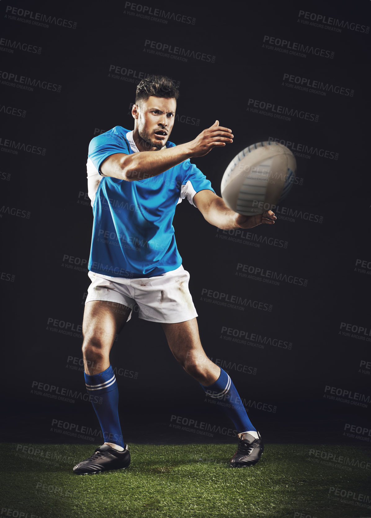 Buy stock photo Night, man and pass ball for rugby sports goal or training for skill for football game or match, professional and athlete. Male person or player, action and energy for competition and fitness workout
