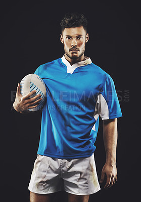 Buy stock photo Rugby, black background and portrait of man athlete with ball in dark studio while training in dirt for wellness and fitness. Exercise, workout and professional sports career of male person or player