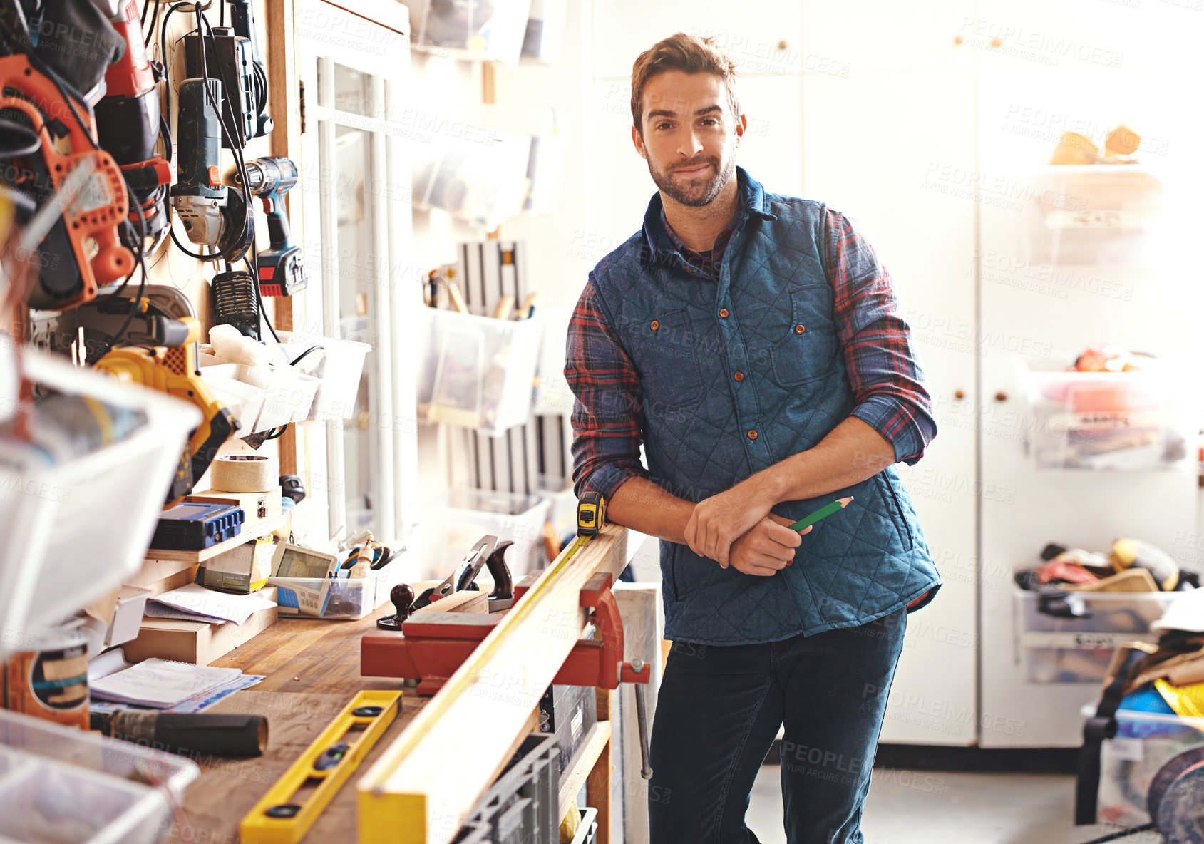 Buy stock photo Carpenter, woodwork and portrait of man in workshop for home development, diy tools and building renovation. Smiling, male employee and contractor for maintenance, equipment and repair work in garage
