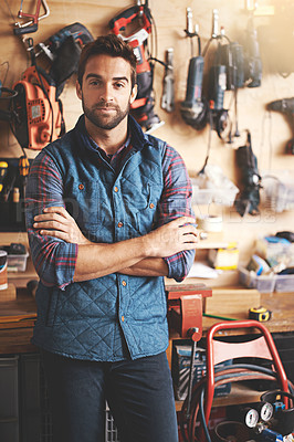 Buy stock photo Man, portrait and tools with arms crossed for diy, home development and renovation in workshop. Carpenter, lens flare and male employee for maintenance, equipment and repair work for construction