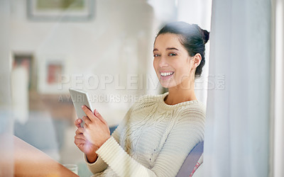 Buy stock photo Shot of  young woman relaxing with a digital tablet at home