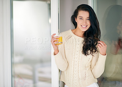 Buy stock photo Portrait of  young woman drinking a glass of juice at home
