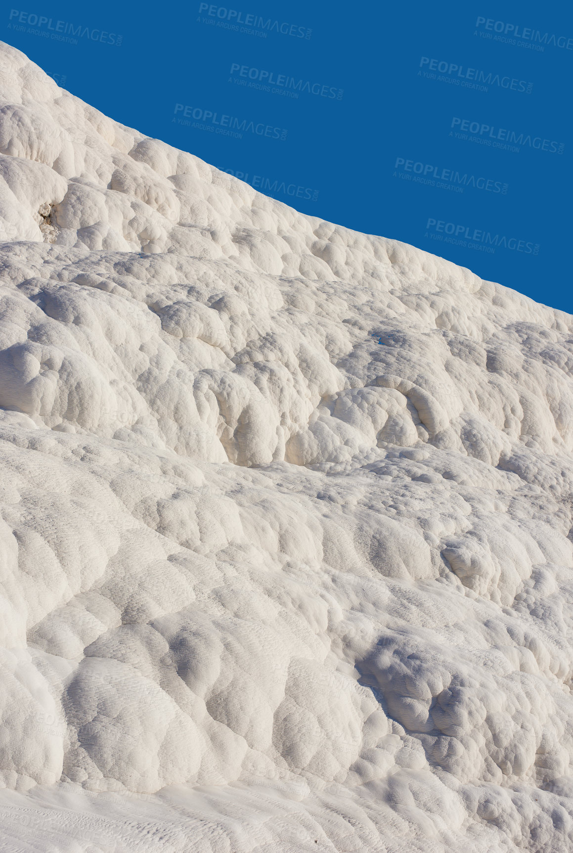 Buy stock photo Scenic view of travertine pools and terraces in Pamukkale, Turkey. Traveling abroad, overseas for vacation and tourism. Cotton castle area with carbonate mineral after flowing thermal spring water