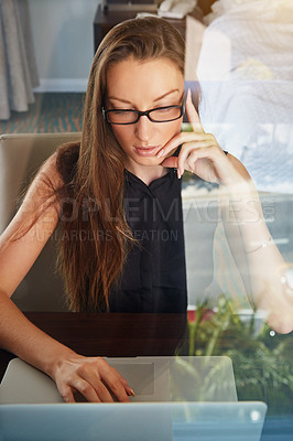 Buy stock photo A young businesswoman working on her laptop in her hotel room