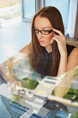 Buy stock photo A young businesswoman working on her laptop in her hotel room