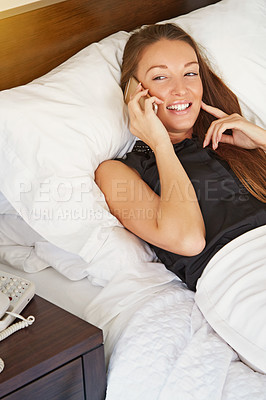 Buy stock photo Cropped shot of a young woman talking on her cellphone in her hotel room