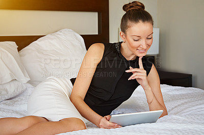 Buy stock photo Shot of a young woman using a digital tablet in her room